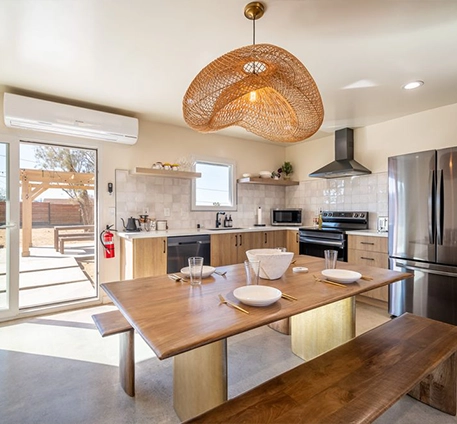 Bright Modern Kitchen with Wooden Dining Table and Stainless Steel Appliances