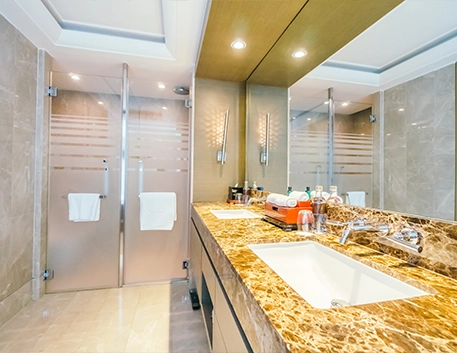 Luxurious Bathroom with Marble Countertop and Dual Glass Showers