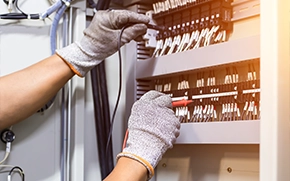 Electrician Performing Electrical Panel Upgrade Alhambra with Tools and Gloves