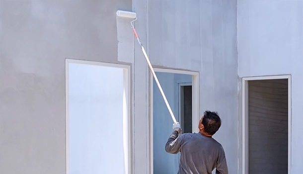 Worker Painting Exterior Wall with Roller, Exterior Painting Alhambra