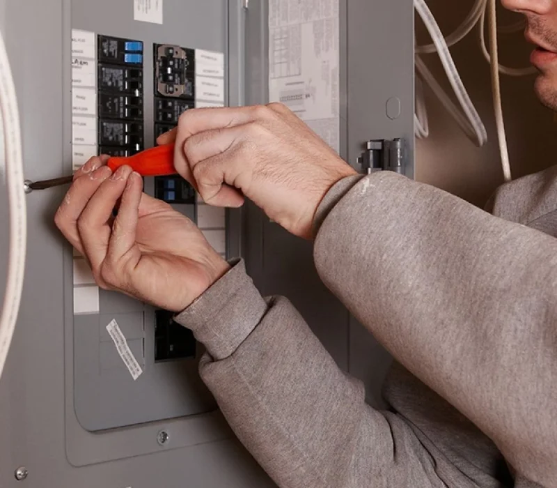 Technician Performing Electrical Panel Upgrade Alhambra with Screwdriver