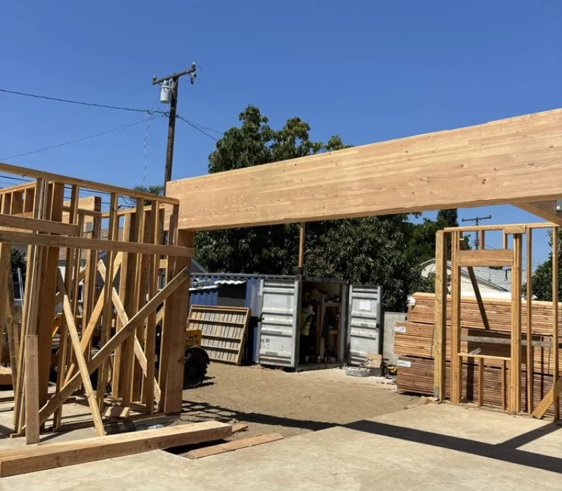 Wooden Framework of a Building Under Construction on a Sunny Day